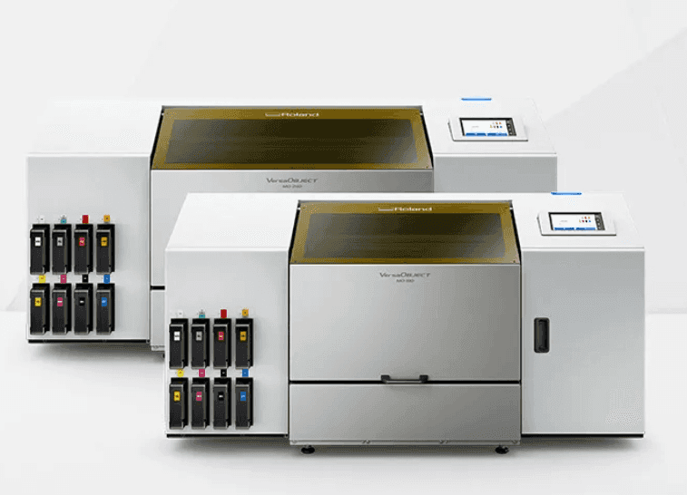 Two industrial printers with digital control screens and ink cartridges on the side.
