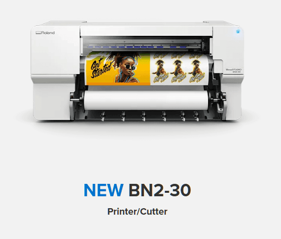 Roland BN2-30 printer and cutter with vibrant prints emerging.