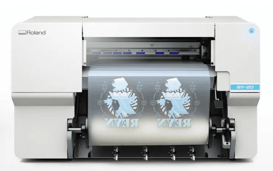 Front view of a Roland BY-20 printer printing detailed graphics onto transparent film.